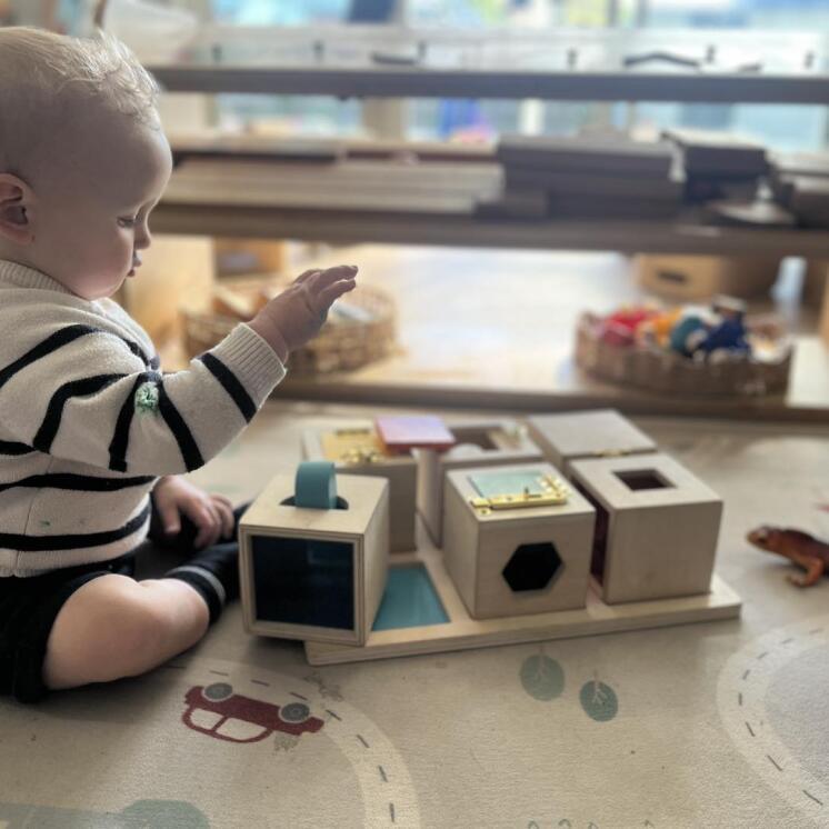 Toddler boy stacking blocks for fine motor skills at Busy Bees Ashburton