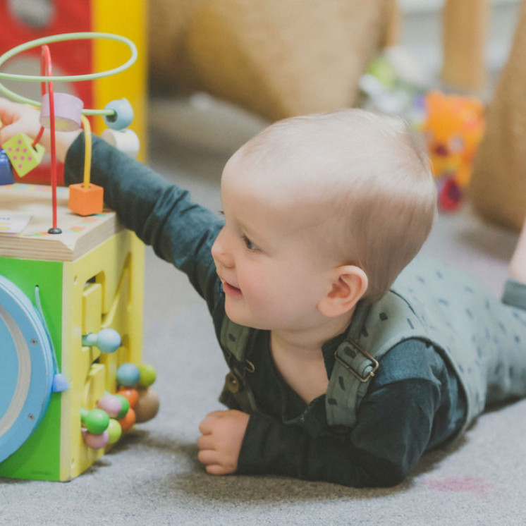 Baby playing with puzzle at Brooklyn Buay Bees