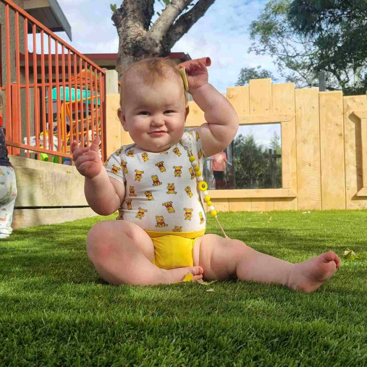 Baby in nursery, outdoors at Busy Bees Carterton