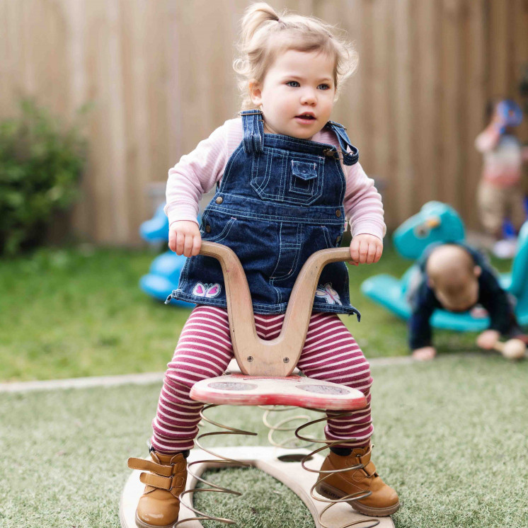 Little girl playing outside at Busy Bees Church Street early childhood learning centre.