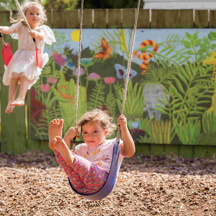 Girls swinging in the sun at Busy Bees Douglas Street