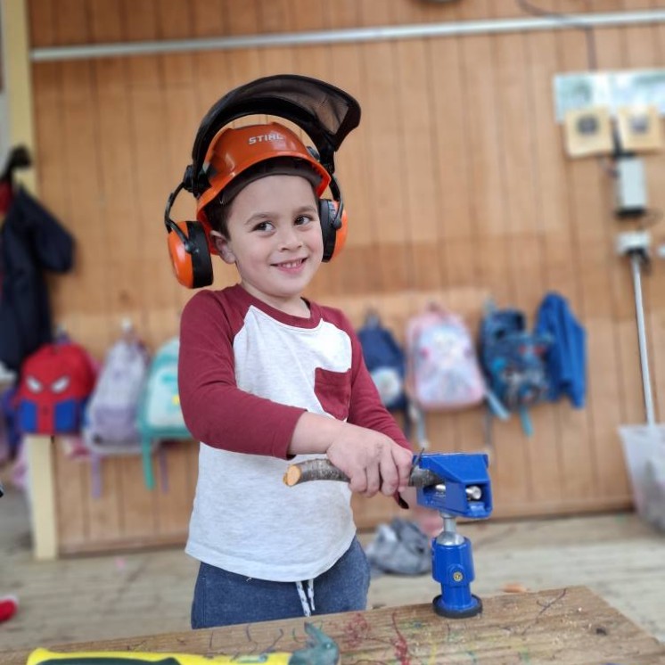 Busy Bees Greytown Boy learning to use tools 