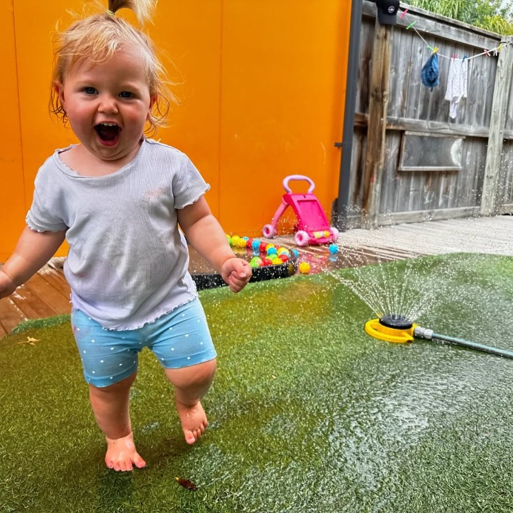 Busy Bees Hastings playing in sprinkler