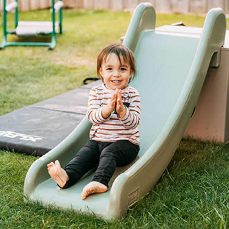 Happy boy on a slide at Busy Bees Judsons Road