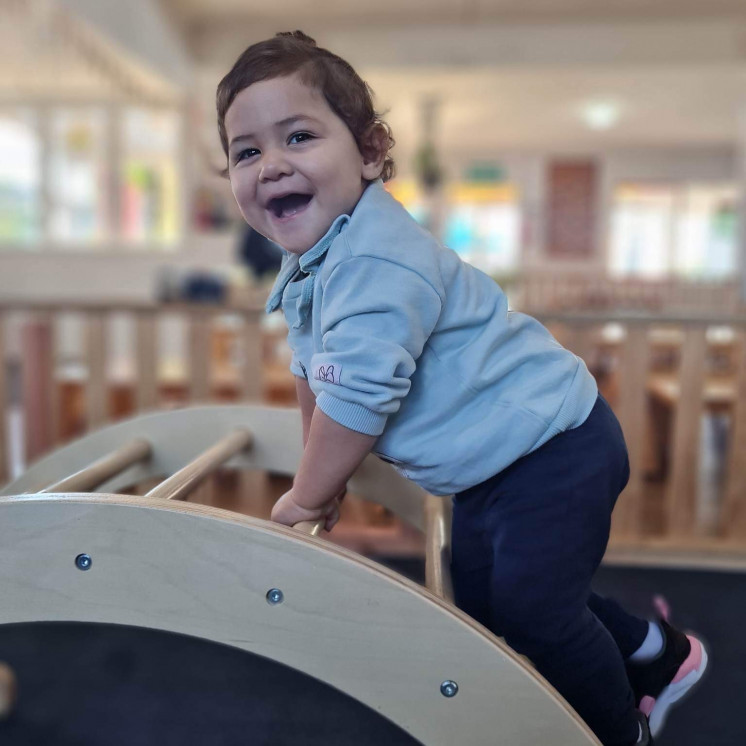 Toddler boy on climbing frame at Busy Bees Katikati