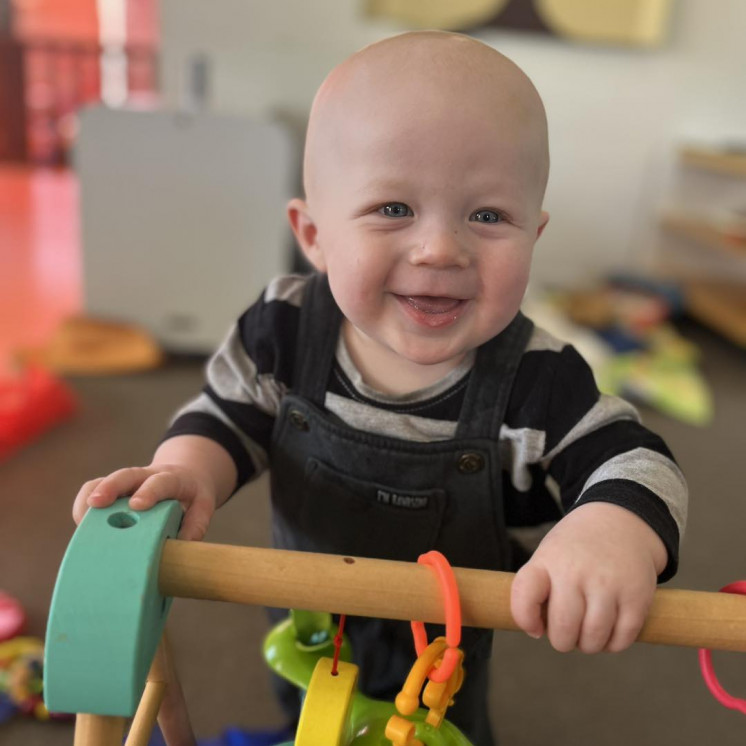 Happy baby in the nursery at Busy Bees Kawatiri