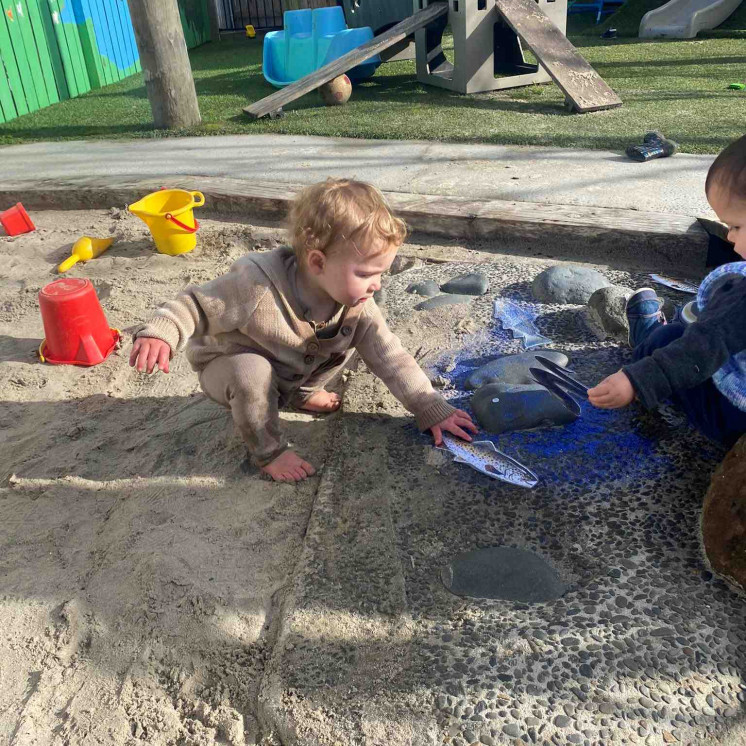 Baby playing in sandpit at Busy Bees Kerikeri Nursery 