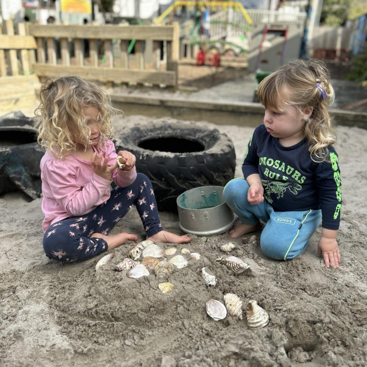 Toddler girls in sandpit outdoors at Busy Bees Kerikeri Nursery 