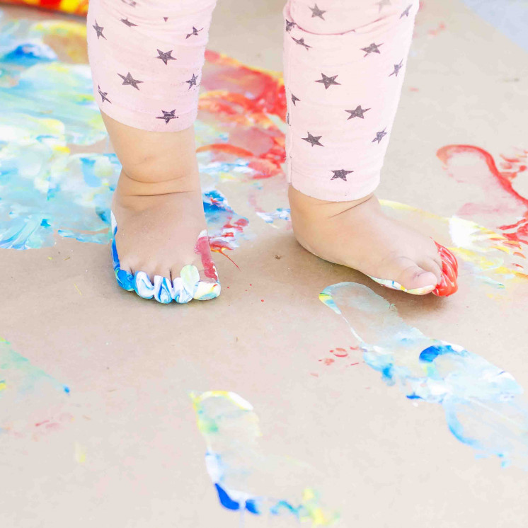 Kids Sensory play painting with feet at Busy Bees Manchester st