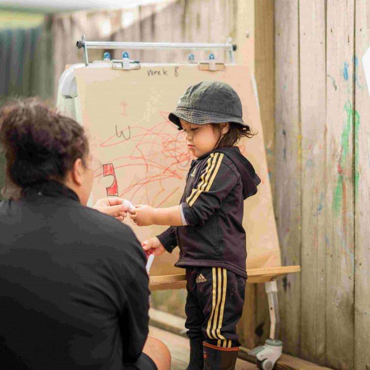 Toddler fee painting  at Busy Bees Mangakakaki