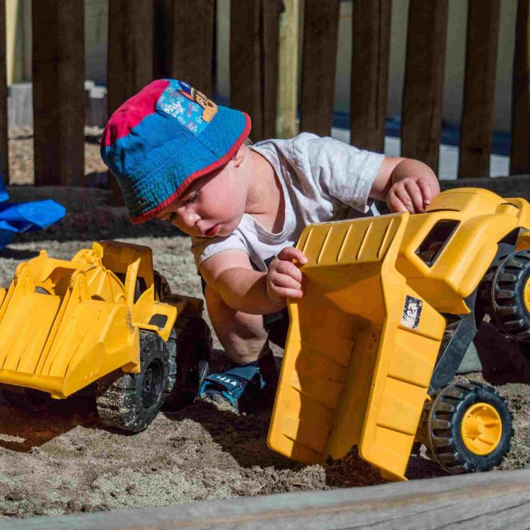 Toddler engaged in real world play at Busy Bees Morrinsville