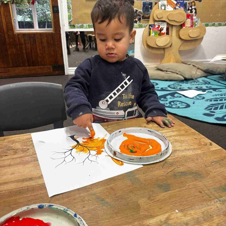 Toddler at Busy Bees Motueka painting