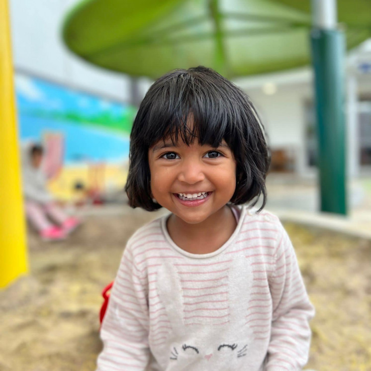 Beautiful happy smiles by young girl at Busy Bees Ormiston Road