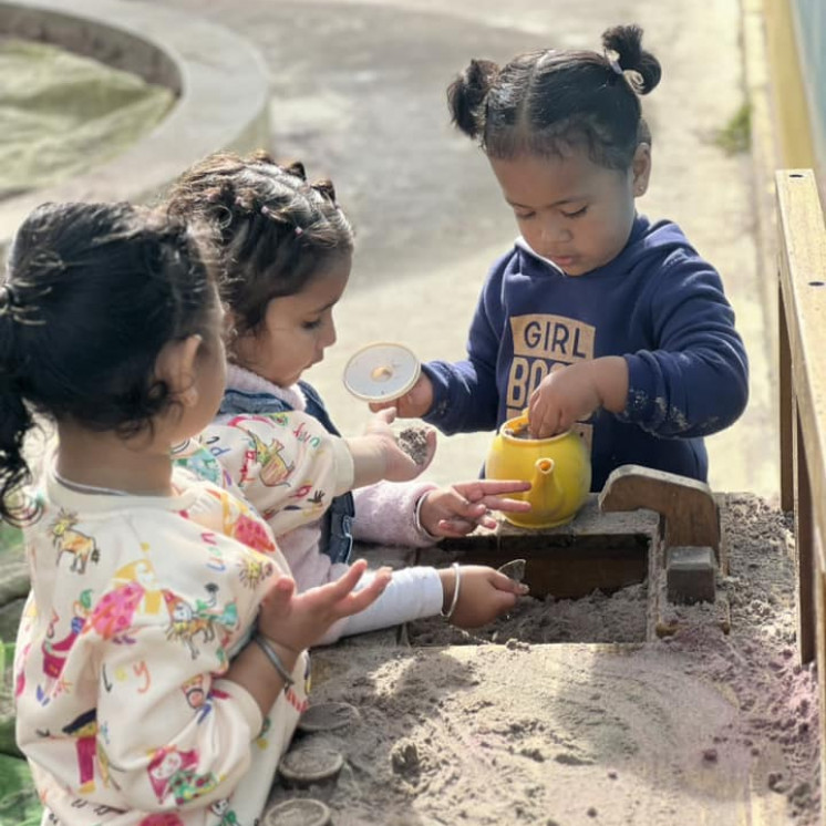 Creating in the mud kitchen at Busy Bees Ormiston Road