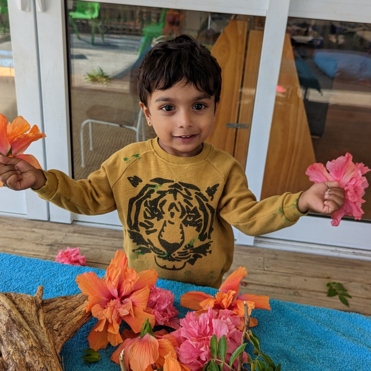 Boy at Busy Bees Ōtāhuhu exploring natures treasures