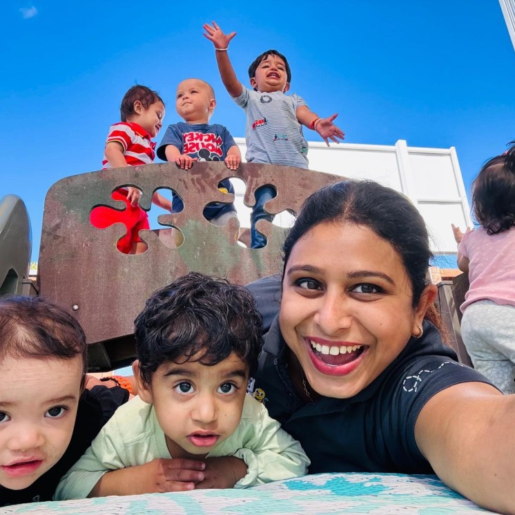Busy Bees Te Rapa kids and teacher outside in sunshine having fun