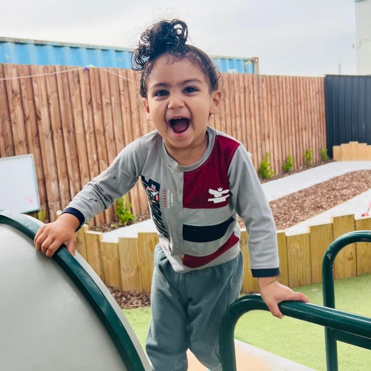 Little boy outside having fun on the playground at Busy Bees Te Rapa