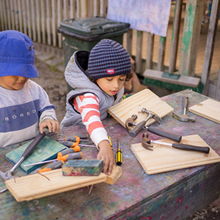 Kids building with hammers and nails at Busy Bees Western Heights