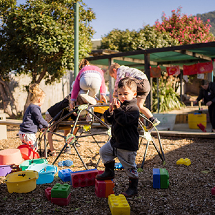 Playing outside on playground at Busy Bees Western Heights